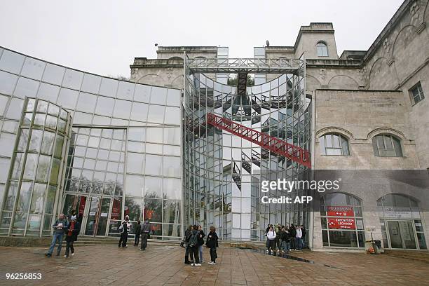 Visitors stand, on January 29 in front of the Cite Internationale de la Bande Dessinee et de l'Image in Angouleme, western France, during the 37th...