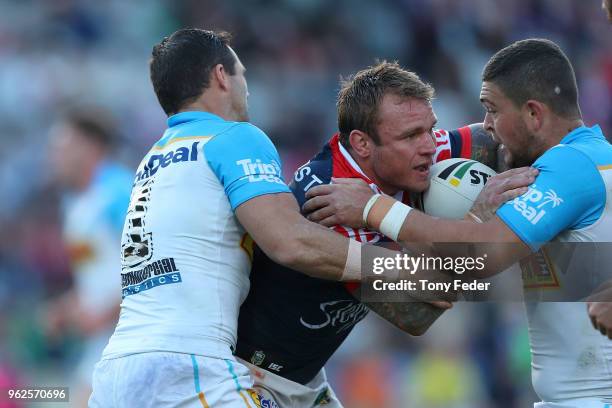 Jake Friend of the Roosters is tackled during the round 12 NRL match between the Sydney Roosters and the Gold Coast Titans at Central Coast Stadium...