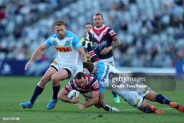 Boyd Cordner of the Roosters is tackled during the round 12 NRL match between the Sydney Roosters and the Gold Coast Titans at Central Coast Stadium...