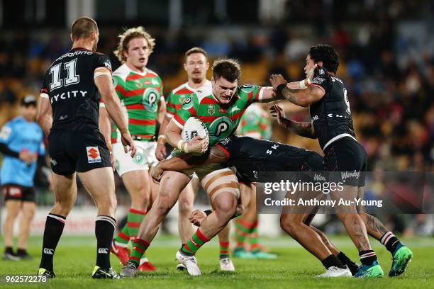 Angus Crichton of the Rabbitohs fends against Issac Luke of the Warriors during the round 12 NRL match between the New Zealand Warriors and the South...
