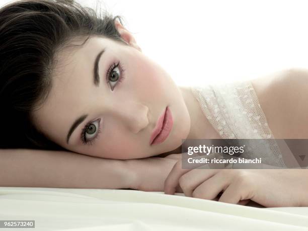 young and romantic woman lying on her side - diastema stock-fotos und bilder