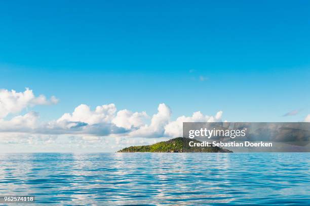 scenic view of seascape against blue sky, island of petite soeur, seychelles - island photos et images de collection