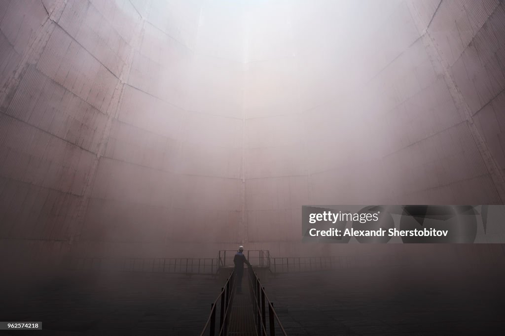 Man standing on walkway in foggy weather