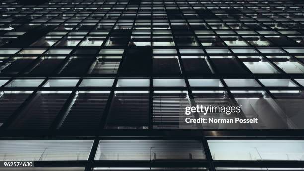 low angle view of illuminated building in city at night - norman window fotografías e imágenes de stock