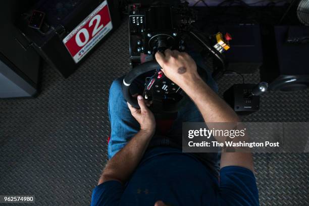 Chris Miller, owner of uRace Simway, tests out one of his racing simulators at the Turn 4 Sun Deck before the start of the Monster Energy NASCAR...