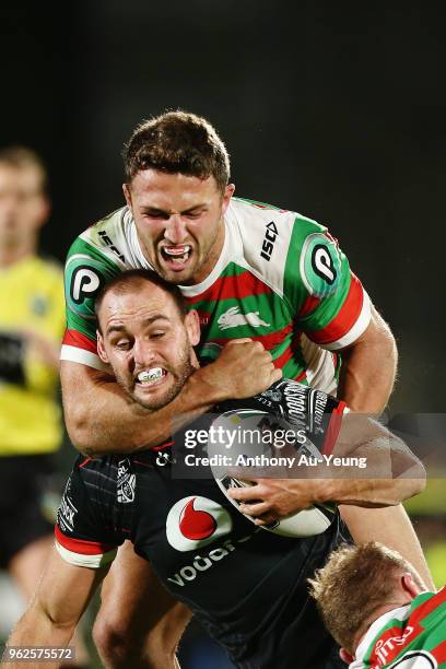 Simon Mannering of the Warriors is tackled by Sam Burgess of the Rabbitohs during the round 12 NRL match between the New Zealand Warriors and the...