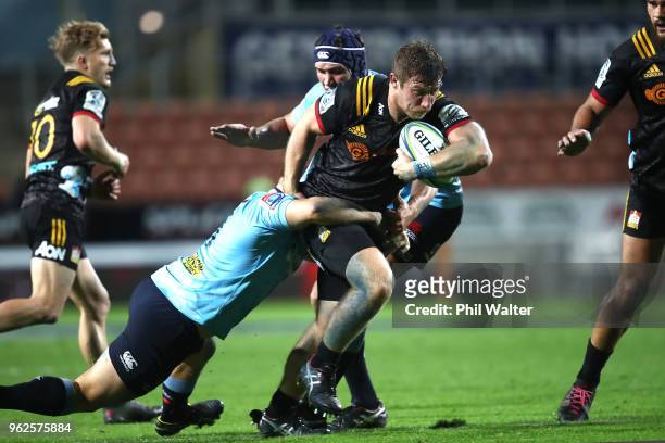 Nathan Harris of the Chiefs is tackled during the round 15 Super Rugby match between the Chiefs and the Waratahs at FMG Stadium on May 26, 2018 in...
