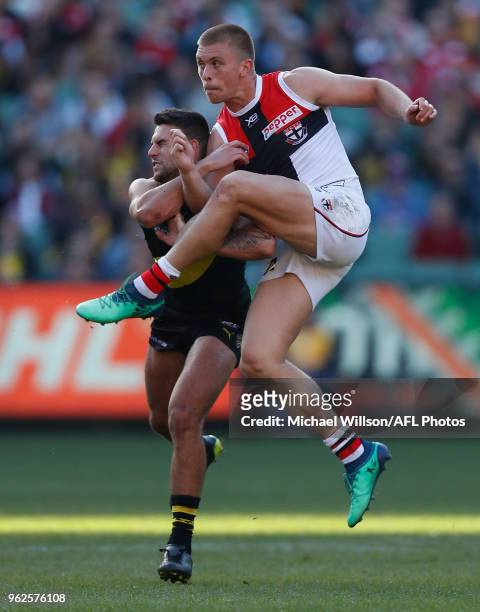 Sebastian Ross of the Saints and Jack Graham of the Tigers in action during the 2018 AFL round 10 match between the Richmond Tigers and the St Kilda...
