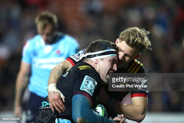 Brodie Retallick of the Chiefs is congreatulated on his try by Damian McKenzie during the round 15 Super Rugby match between the Chiefs and the...
