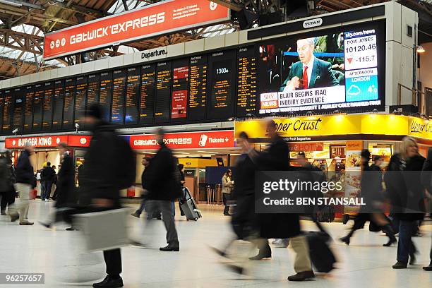 Giant television screen showing former British Prime Minister Tony Blair giving evidence to the Iraq War Inquiry is pictured in a train station in...