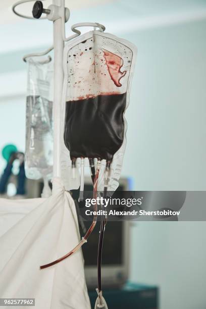 close-up of blood bag hanging in hospital - blood bag stock pictures, royalty-free photos & images
