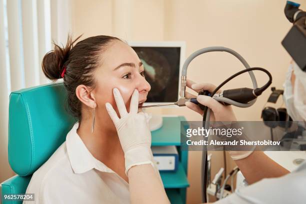 cropped image of doctor using equipment while examining patient's mouth at hospital - sherstobitov stock pictures, royalty-free photos & images
