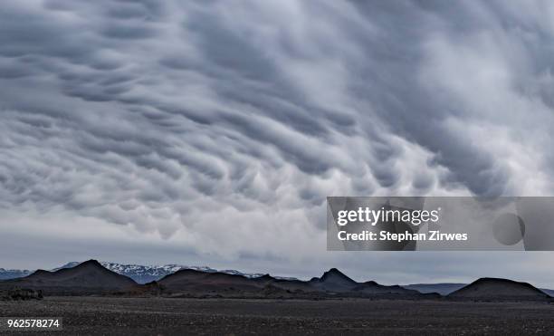 idyllic shot of landscape against cloudy sky, iceland - mammatus cloud stock pictures, royalty-free photos & images