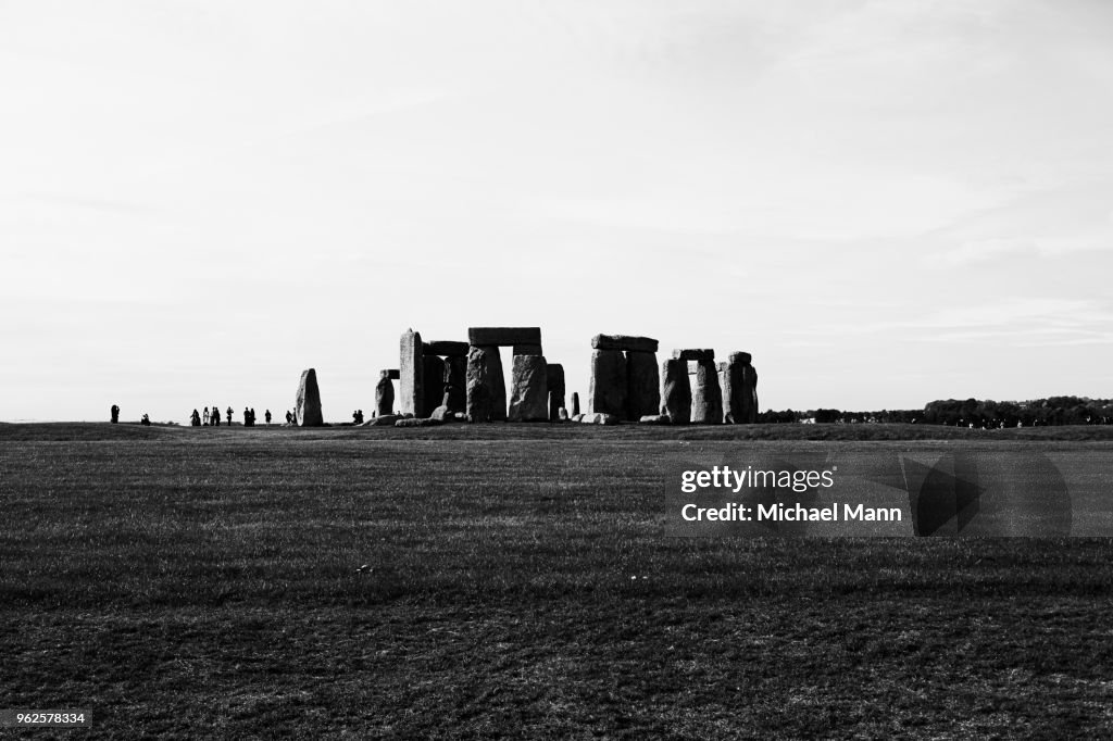 View of Stonehenge in mid distance against sky, Wiltshire, United Kingdom