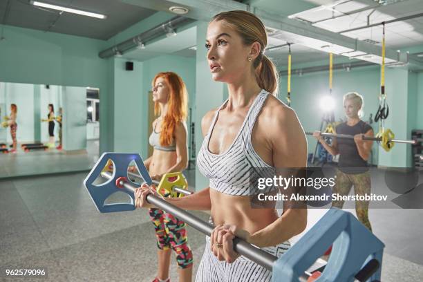 women exercising with barbells in gym - sherstobitov stock pictures, royalty-free photos & images