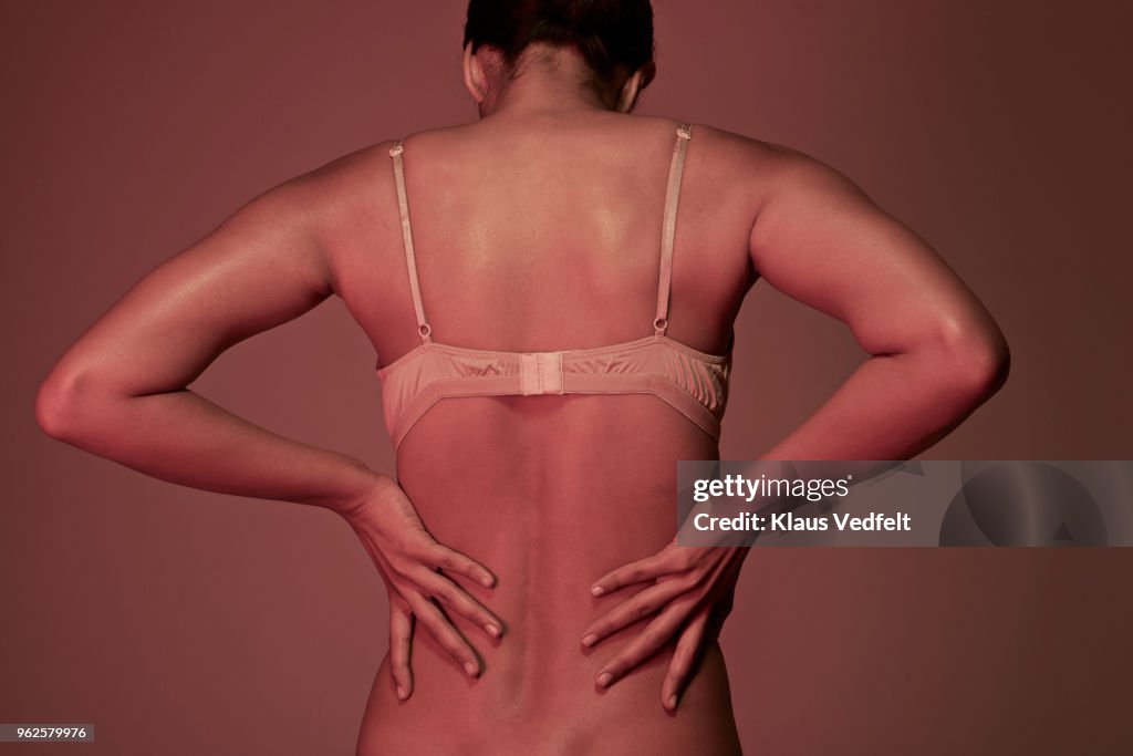 Rear view of woman having back pain