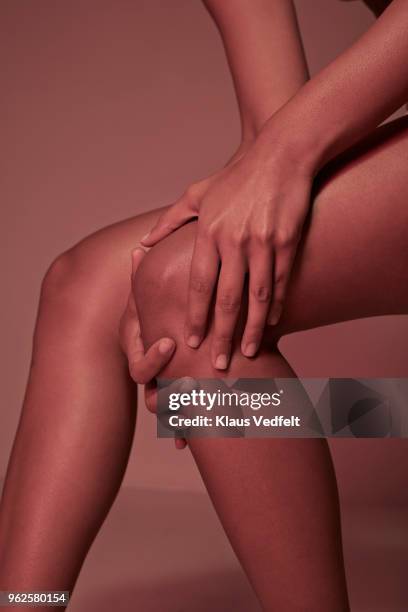 cropped image of woman having knee pains - benton bildbanksfoton och bilder