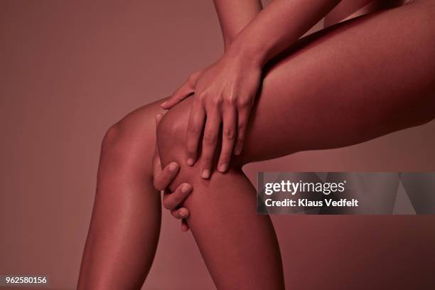 cropped image of woman having knee pains - female legs studio shot stock pictures, royalty-free photos & images