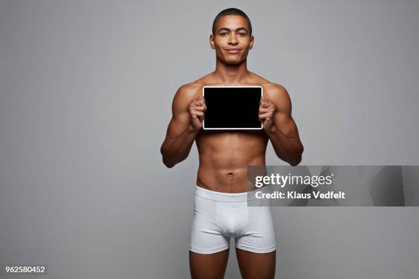 man holding tablet in front of his chest - tronco nu imagens e fotografias de stock