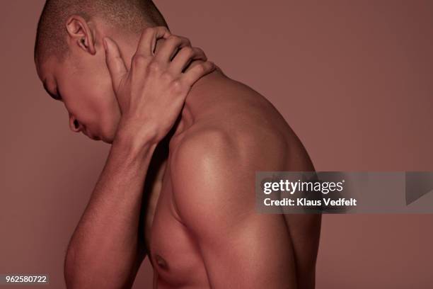 young man having neck pain - man touching shoulder stock pictures, royalty-free photos & images