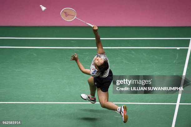 Japan's Nozomi Okuhara hits a return against Thailand's Nitchaon Jindapol during their womens singles final match at the Thomas and Uber Cup...