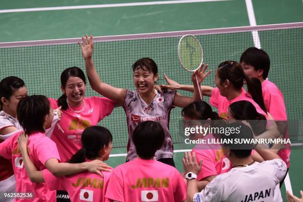 Japan's Nozomi Okuhara celebreates with teammates after defeating Thailand's Nitchaon Jindapol during their womens singles final match at the Thomas...