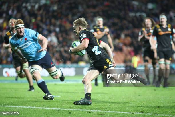 Damian McKenzie of the Chiefs runs in for a try during the round 15 Super Rugby match between the Chiefs and the Waratahs at FMG Stadium on May 26,...