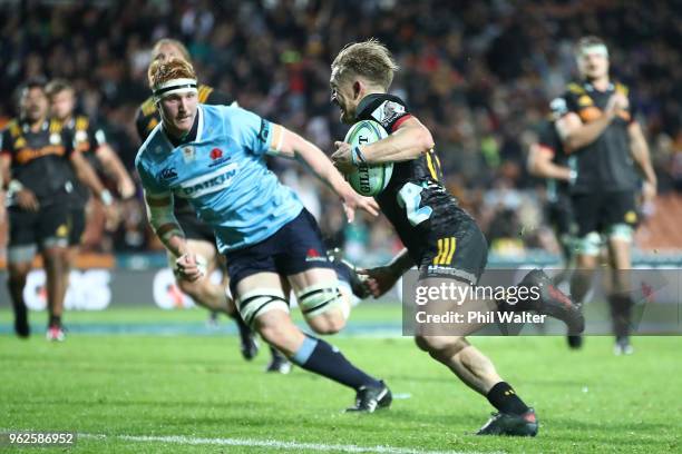 Damian McKenzie of the Chiefs runs in for a try during the round 15 Super Rugby match between the Chiefs and the Waratahs at FMG Stadium on May 26,...