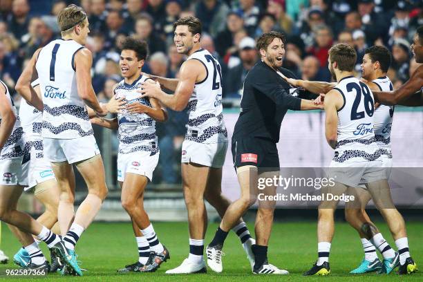 Debutant Jamaine Jones of the Cats celebrates a goal as Dale Thomas of the Blues tries to intervene during the round 10 AFL match between the Geelong...