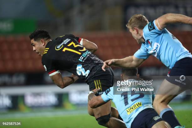 Anton Leinert-Brown of the Chiefs is tacked by Israel Folau of the Waratahs during the round 15 Super Rugby match between the Chiefs and the Waratahs...