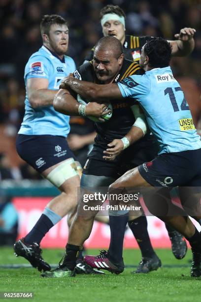 Karl Tu'inukuafe of the Chiefs is tackled during the round 15 Super Rugby match between the Chiefs and the Waratahs at FMG Stadium on May 26, 2018 in...