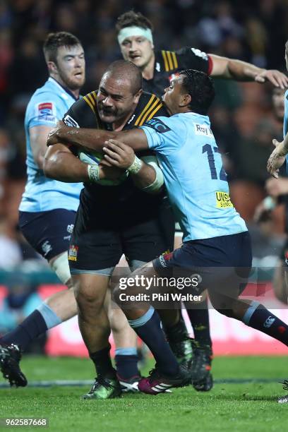 Karl Tu'inukuafe of the Chiefs is tackled during the round 15 Super Rugby match between the Chiefs and the Waratahs at FMG Stadium on May 26, 2018 in...