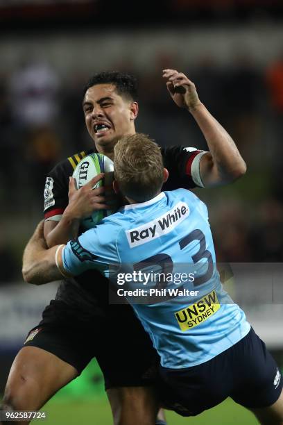 Anton Leinert-Brown of the Chiefs is tackled by Bryce Hegarty of the Waratahs during the round 15 Super Rugby match between the Chiefs and the...