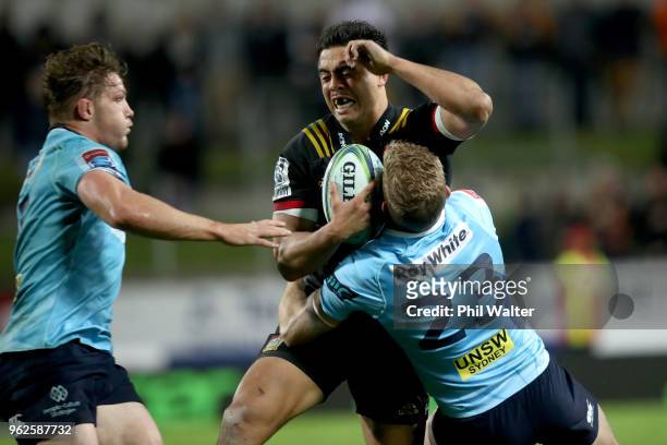 Anton Leinert-Brown of the Chiefs is tackled by Bryce Hegarty of the Waratahs during the round 15 Super Rugby match between the Chiefs and the...