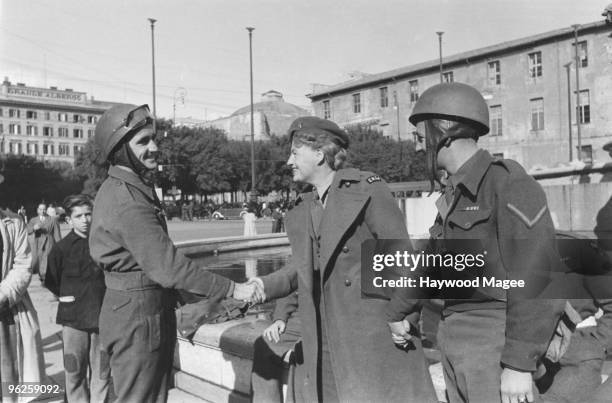 English singer and comedienne Gracie Fields meets members of the Allied Forces in Rome during an ENSA tour of Italy, December 1945. Original...