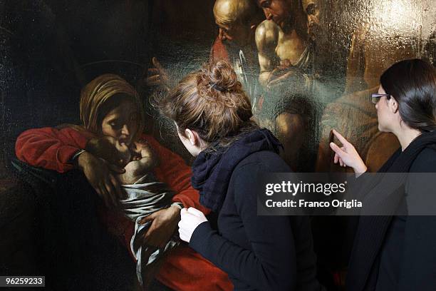 Restorers work on Caravaggio's masterpiece 'Adoration Of The Shepherds' during the open restoration at the Chamber Of Deputies facing Piazza del...
