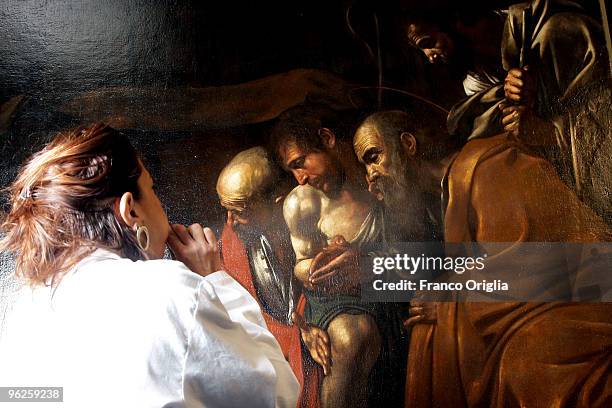 Restorer Daniela Storti works on Caravaggio's masterpiece 'Adoration Of The Shepherds' during the open restoration at the Chamber Of Deputies facing...