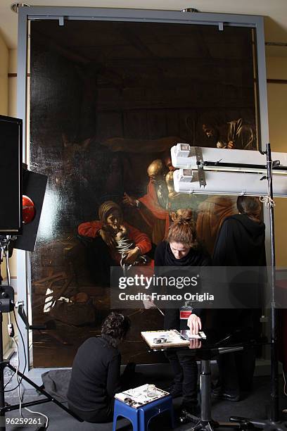 Restorers work on Caravaggio's masterpiece 'Adoration Of The Shepherds' during the open restoration at the Chamber Of Deputies facing Piazza del...