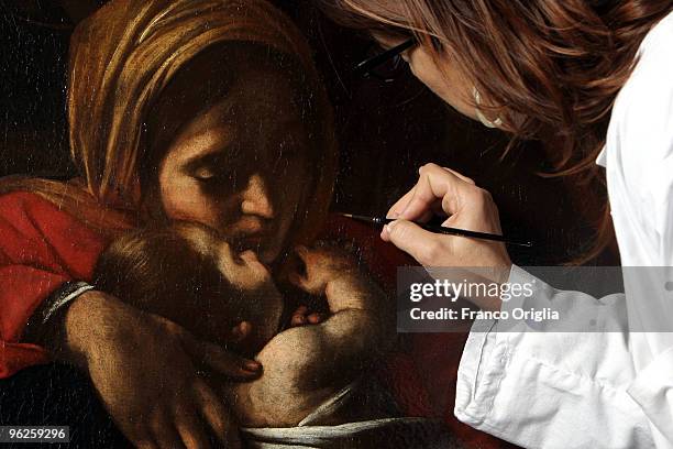 Restorer Daniela Storti works on Caravaggio's masterpiece 'Adoration Of The Shepherds' during the open restoration at the Chamber Of Deputies facing...