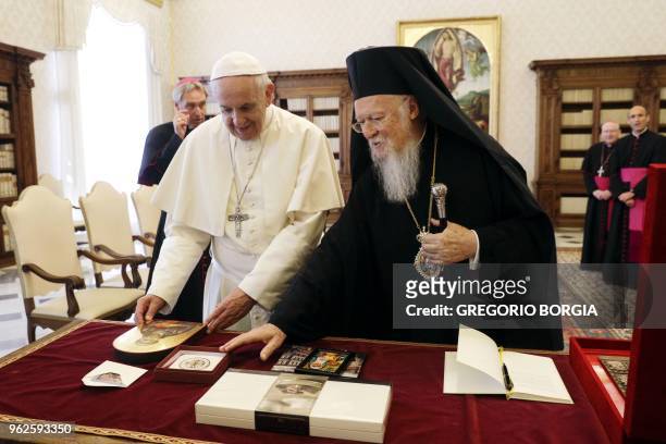 Pope Francis and Bartholomew I , current Archbishop of Constantinople and Ecumenical Patriarch, exchange gifts during a private audience at the...
