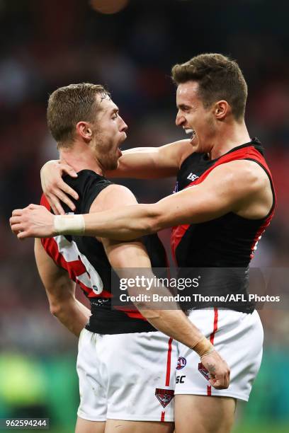 Orazio Fantasia of the Bombers celebrates kicking a goal with team mate Devon Smith during the round 10 AFL match between the Greater Western Sydney...