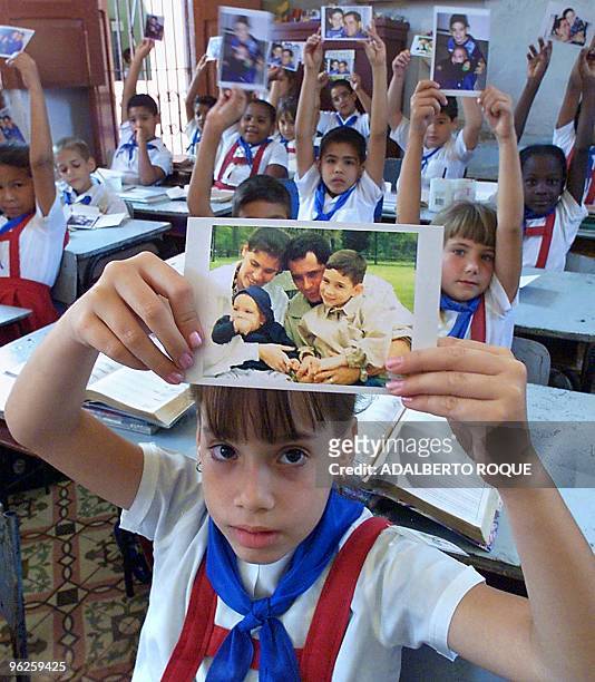 Loraine Marquez, 8 years old and a companion of Elian Gonzalez, holds up a picture of Elian 28 April 2000 in Cardenas, Cuba. Loraine Marquez, de 8...