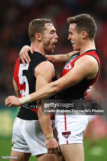 Orazio Fantasia of the Bombers celebrates kicking a goal with team mate Devon Smith during the round 10 AFL match between the Greater Western Sydney...