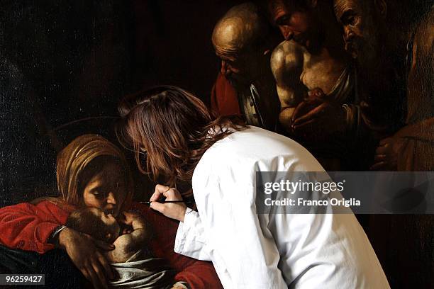 Restorer Daniela Storti works on Caravaggio's masterpiece 'Adoration Of The Shepherds' during the open restoration at the Chamber Of Deputies facing...