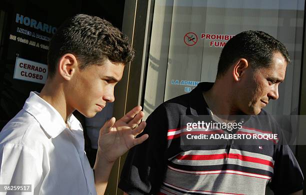 Cuban "balsero" child Elian Gonzalez and his father Juan Miguel Gonzalez take part 06 December, 2006 in Cardenas, 150 km east from Havana in a...