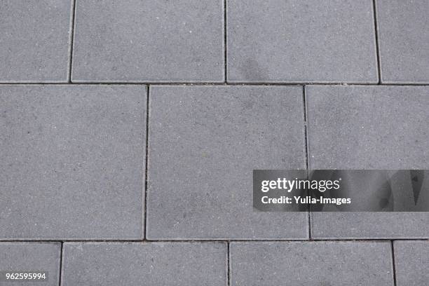 textured grey square tiles for paving - pavement stockfoto's en -beelden