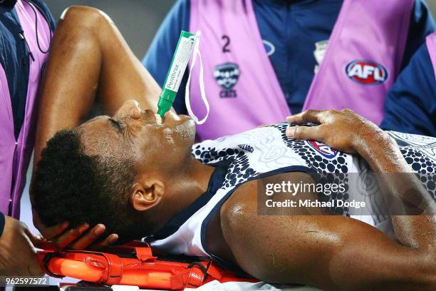 Esava Ratugolea of the Cats reacts in pain after injuring himself in a contest during the round 10 AFL match between the Geelong Cats and the Carlton...