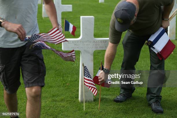 Workers and volunteers plant U.S. And French flags at the graves of U.S. Soldiers, most of them killed in the World War I Battle of Belleau Wood, at...