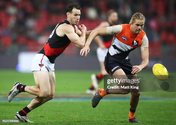 Matt Dea of the Bombers competes for the ball against Harrison Himmelberg of the Giants during the round 10 AFL match between the Greater Western...