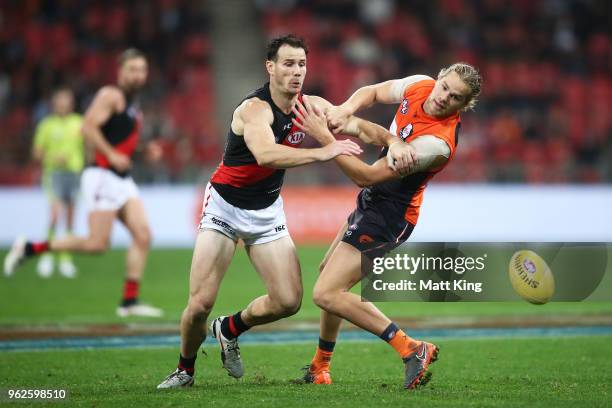 Matt Dea of the Bombers competes for the ball against Harrison Himmelberg of the Giants during the round 10 AFL match between the Greater Western...